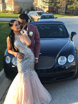 They bring the glam, her in a dress that outshines the stars, him in a suit that's all class!: party outfits,  Backless dress,  Sleeveless shirt,  Black Couple Homecoming Dresses  