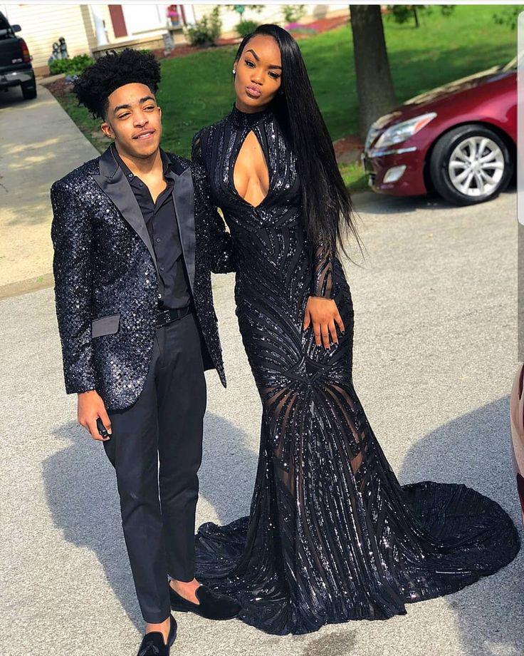 Look at her, a vision in shimmering black, and him, all dapper in his dark blazer!: Sheath dress,  See-Through Clothing,  Bow tie,  Black Couple Homecoming Dresses  